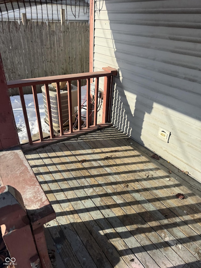 wooden deck with central air condition unit