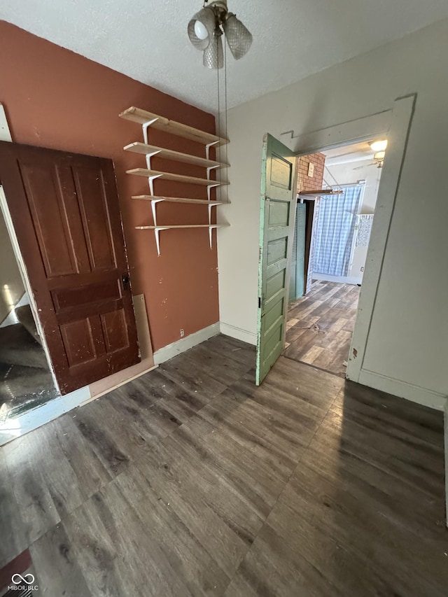 unfurnished dining area featuring dark wood-type flooring and ceiling fan