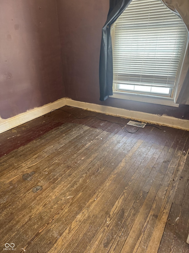 empty room with hardwood / wood-style flooring