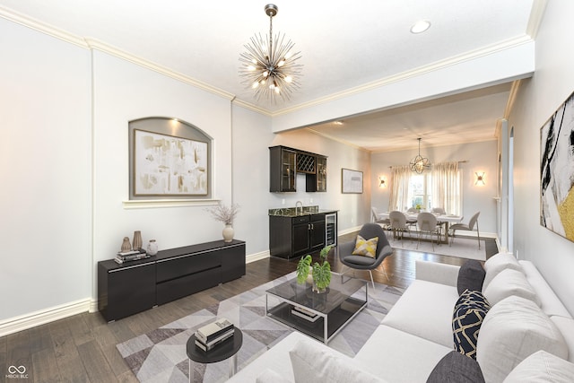 living room with dark hardwood / wood-style floors, an inviting chandelier, and ornamental molding