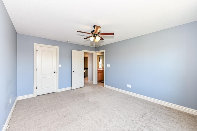 unfurnished bedroom with light colored carpet and ceiling fan