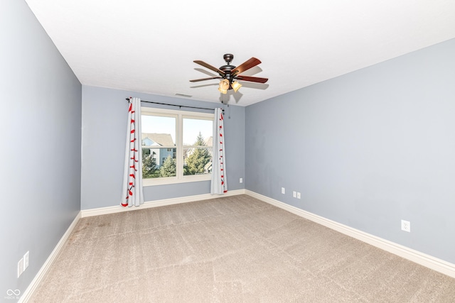 carpeted spare room featuring ceiling fan