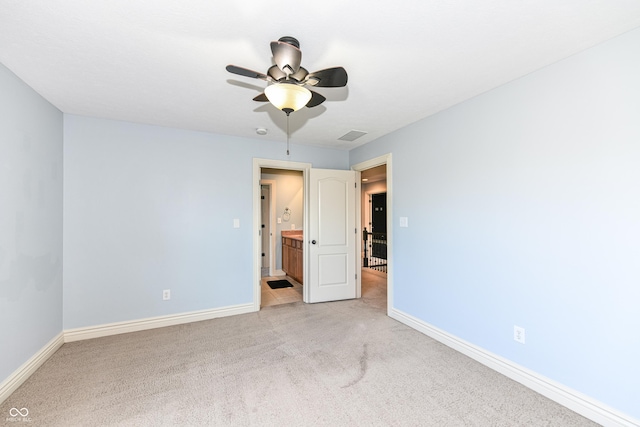 unfurnished room with light carpet and ceiling fan