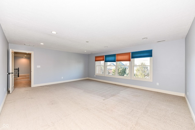 spare room with light colored carpet