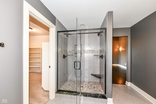 bathroom with tile patterned flooring and a shower with door