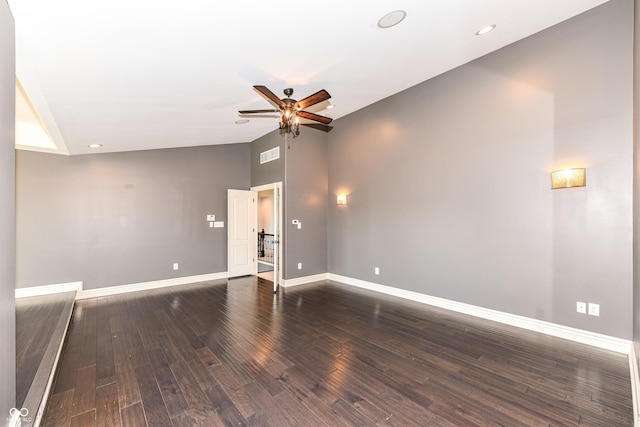 spare room featuring vaulted ceiling, ceiling fan, and dark wood-type flooring