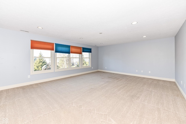 carpeted empty room with a wealth of natural light