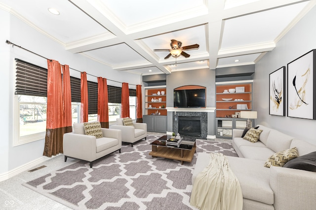 carpeted living room featuring coffered ceiling, ceiling fan, crown molding, built in features, and beamed ceiling