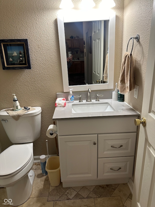 bathroom with vanity, toilet, and tile patterned flooring