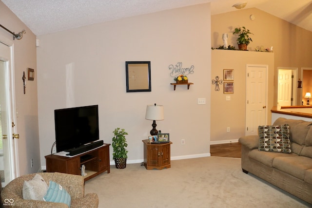 living room featuring lofted ceiling, carpet floors, and a textured ceiling