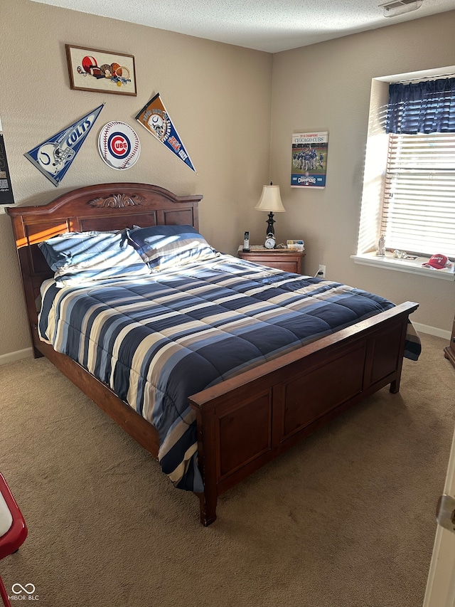 bedroom with a textured ceiling and carpet flooring