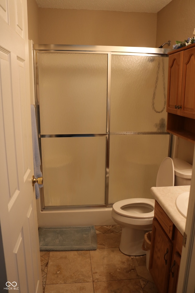 bathroom with a shower with door, toilet, a textured ceiling, and vanity