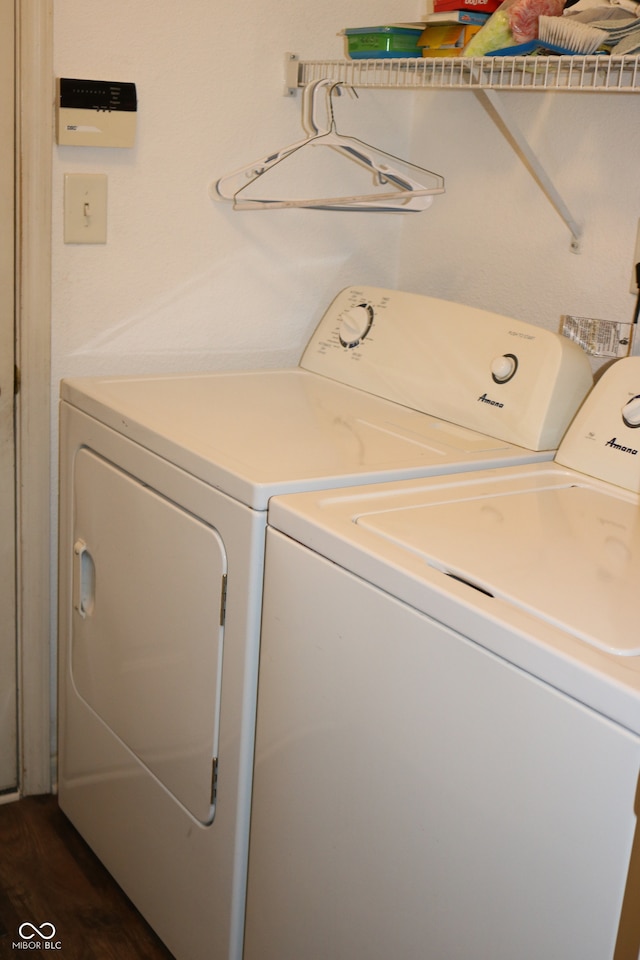 laundry room with washer and clothes dryer and dark hardwood / wood-style floors