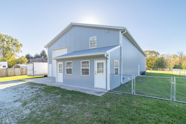 back of property featuring a patio and a lawn