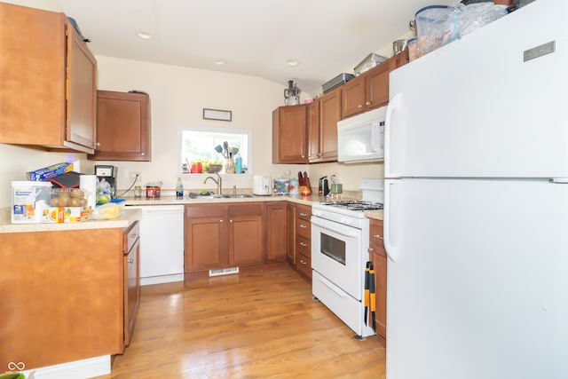 kitchen featuring light hardwood / wood-style floors, sink, and white appliances