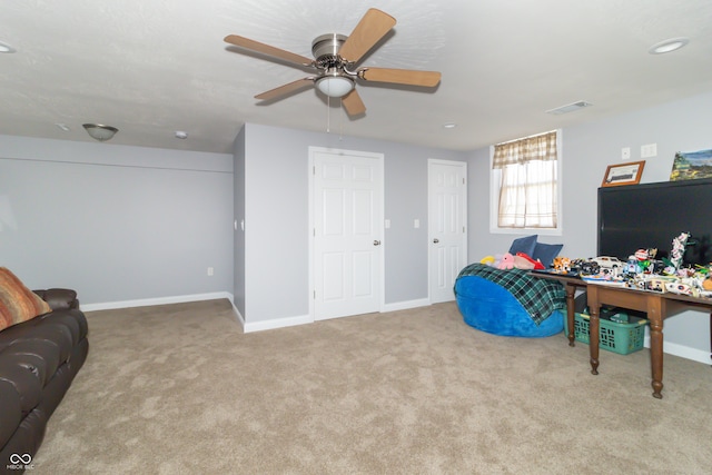 interior space with light carpet and ceiling fan