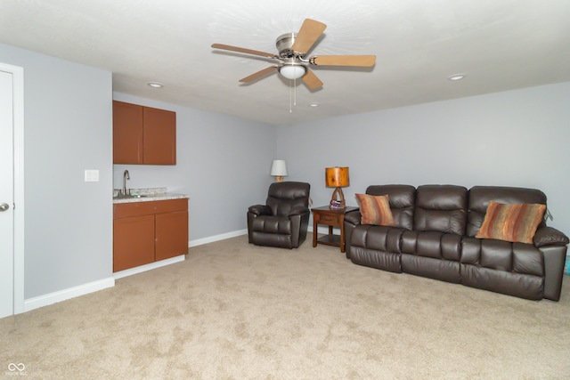 living room with light carpet, indoor wet bar, and ceiling fan