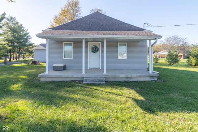 bungalow-style house with a front yard and covered porch