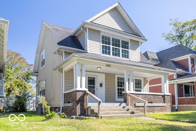 view of front of house featuring a porch and a front lawn