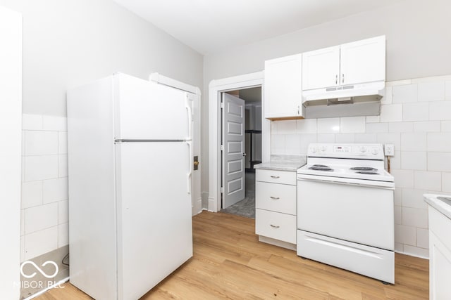 kitchen with light hardwood / wood-style flooring, white refrigerator, tile walls, white cabinetry, and electric stove