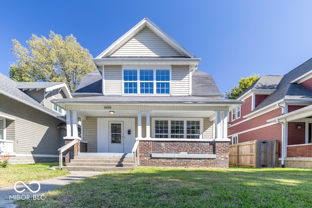 view of front of house featuring a front yard and a porch