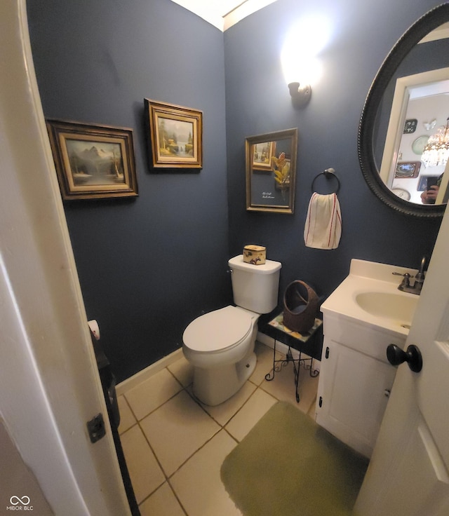 bathroom with vanity, tile patterned floors, baseboards, and toilet