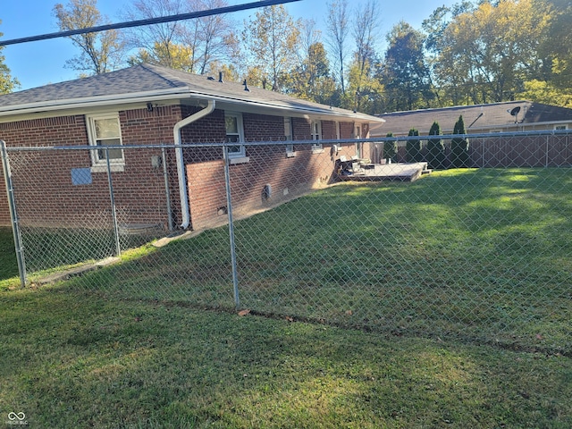 view of side of property featuring brick siding, fence, a yard, and crawl space