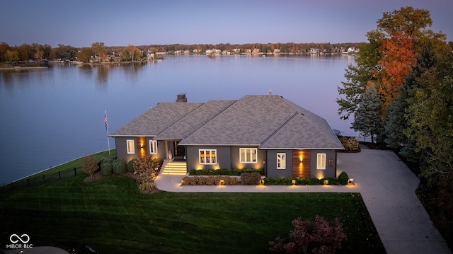 view of front of home featuring a water view and a lawn