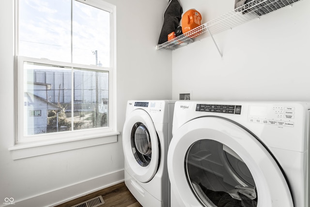 laundry room with washing machine and dryer and dark hardwood / wood-style flooring