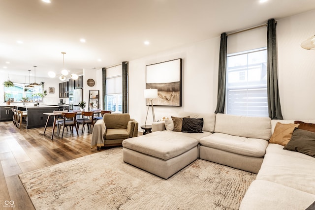 living room with hardwood / wood-style floors and a chandelier