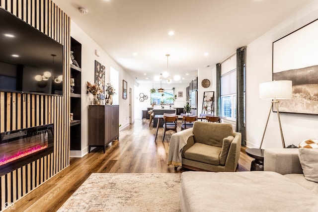 living room with a chandelier and wood-type flooring