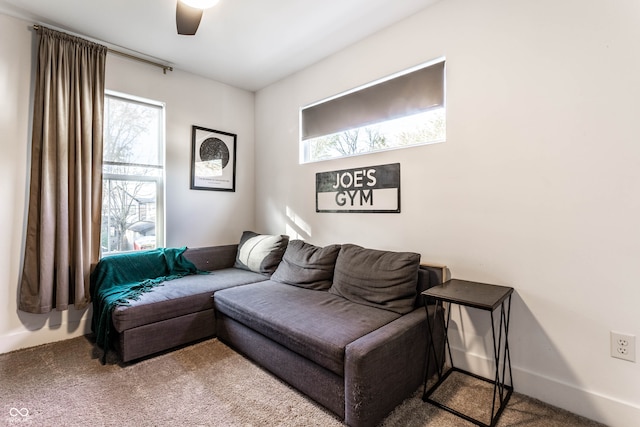 living room featuring carpet and ceiling fan