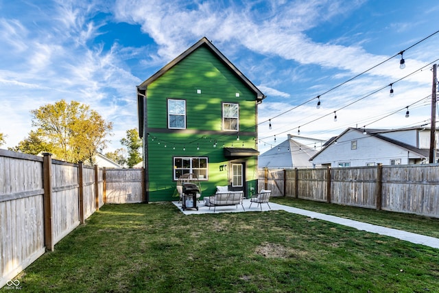 back of property featuring a yard, a patio, and outdoor lounge area