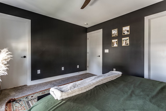 unfurnished bedroom with ceiling fan and carpet