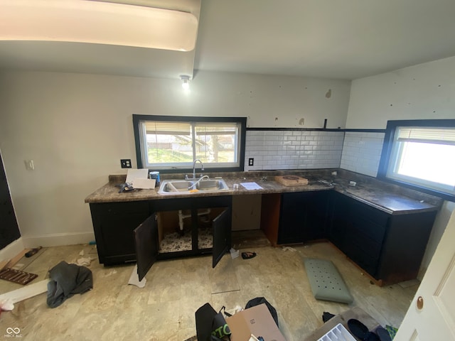 kitchen featuring sink, backsplash, and a wealth of natural light