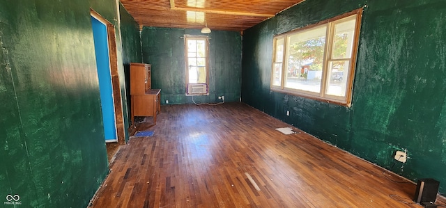 unfurnished room with wood ceiling and dark hardwood / wood-style floors