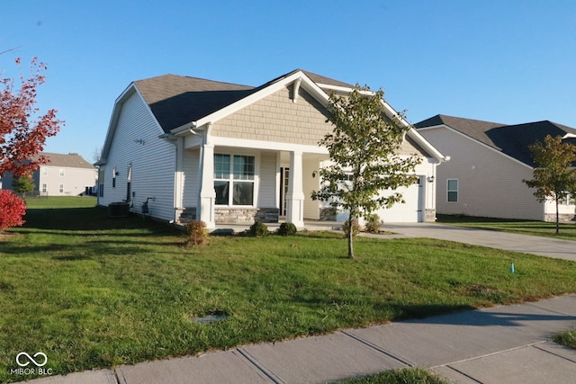 view of front of home with covered porch, a front yard, and a garage