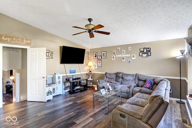 living room featuring vaulted ceiling, ceiling fan, a textured ceiling, and dark hardwood / wood-style flooring