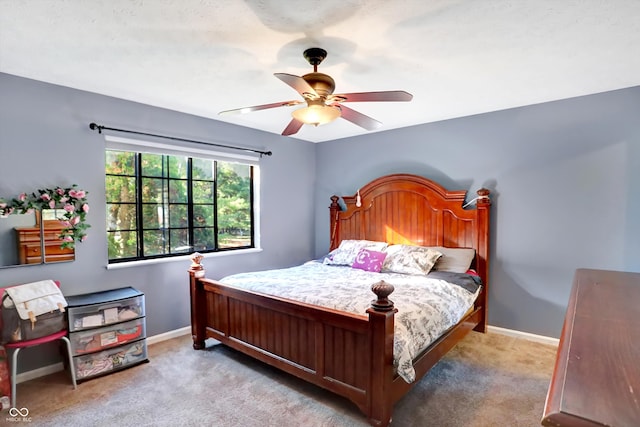 bedroom with ceiling fan and light carpet