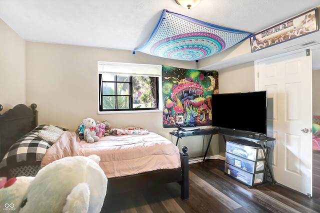 bedroom with dark hardwood / wood-style flooring and vaulted ceiling