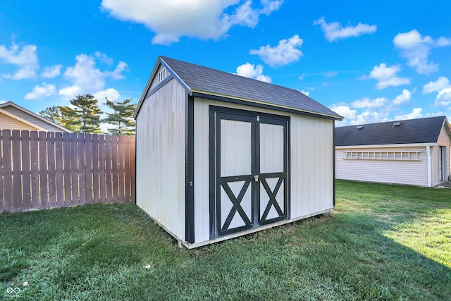 view of outdoor structure featuring a lawn