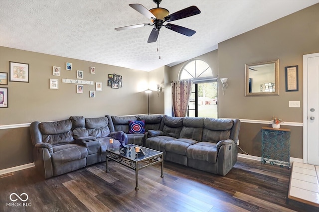 living room featuring dark hardwood / wood-style flooring, a textured ceiling, and ceiling fan