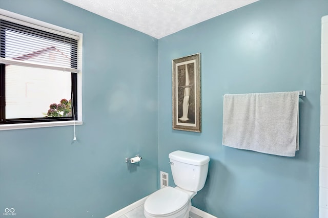 bathroom featuring toilet and a textured ceiling