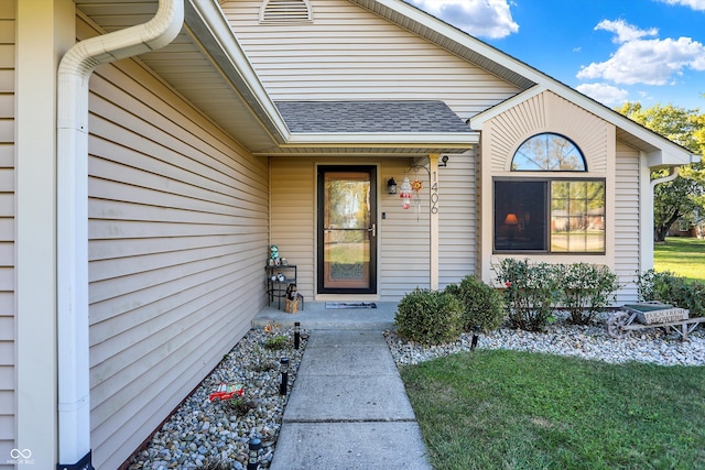 property entrance featuring a lawn