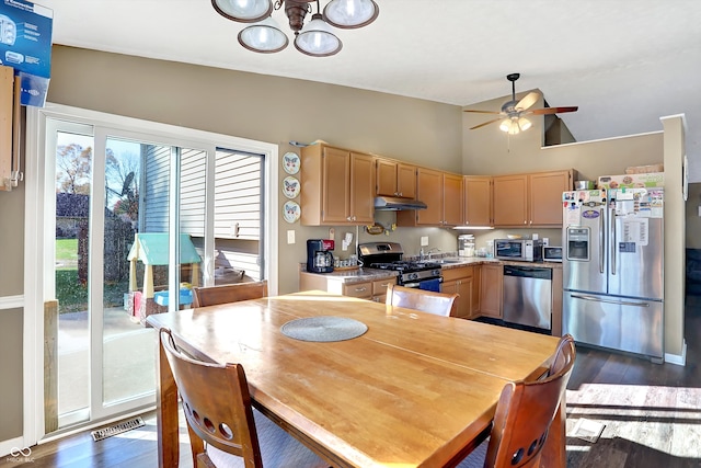 kitchen featuring appliances with stainless steel finishes, dark hardwood / wood-style flooring, high vaulted ceiling, light brown cabinets, and ceiling fan