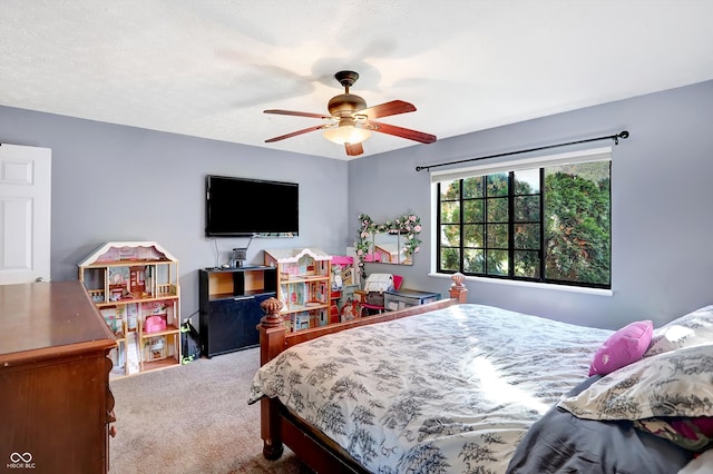 bedroom featuring a textured ceiling, ceiling fan, and carpet floors