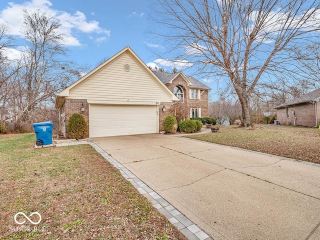 view of front of property with a front lawn, driveway, an attached garage, and brick siding