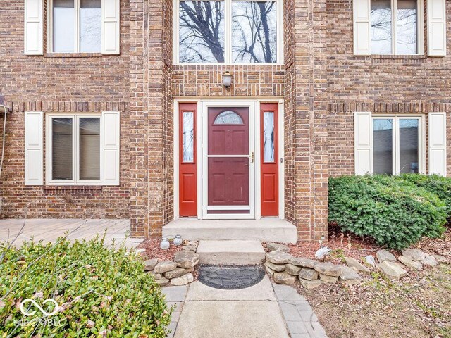 property entrance featuring brick siding