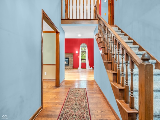 foyer featuring stairs, wood finished floors, and baseboards