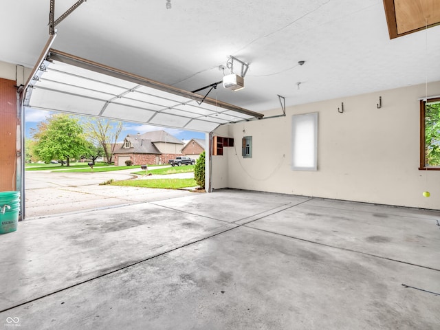 garage with electric panel and a garage door opener